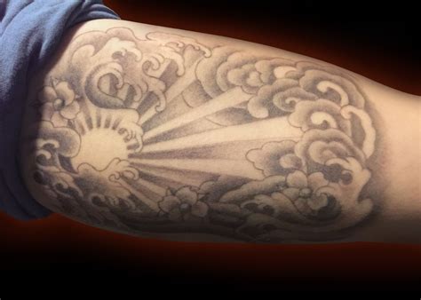 Sun tattoo japanese wave cloud black and grey bicep tattoo | Cloud