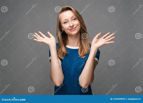 Positive Young Female Is Smiling Happily And Spreads Her Hands To The Side Human Emotions