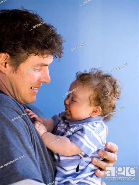Man Holding Baby Boy Smiling Stock Photo Picture And Royalty Free