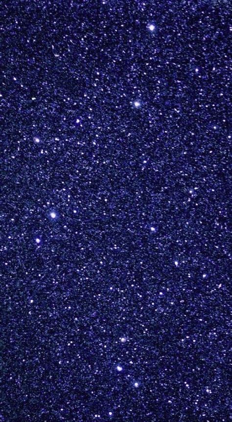 The Night Sky Is Full Of Stars And Bright Blue Hues As Well As White Dots
