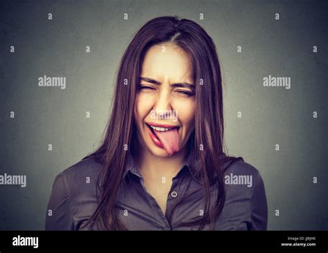 Portrait Of Beautiful Woman In Casual Clothes Showing Her Tongue Stock