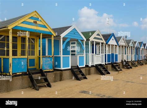 A Row Of Colourful Beach Huts Under A Blue Sky At Southwold Beach In