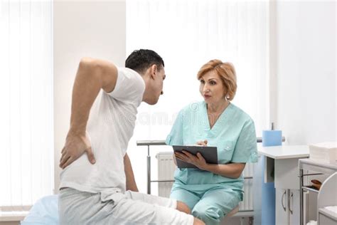 Orthopedist And Patient With Back Pain In Hospital Stock Photo Image