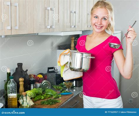girl standing at kitchen and cooking soup stock image image of american mixing 77162957