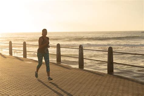 Female Jogger Running On Seaside At The Sunset Stock Photo Image Of