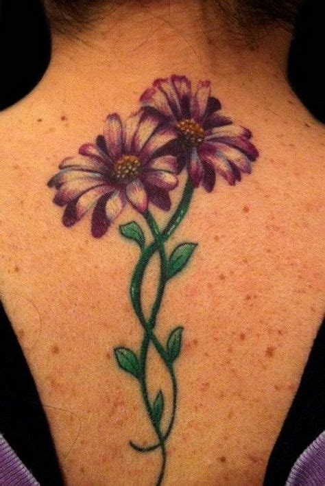 Beautiful Purple Daisy Buds On Green Stems Tattoo On Upper Arm