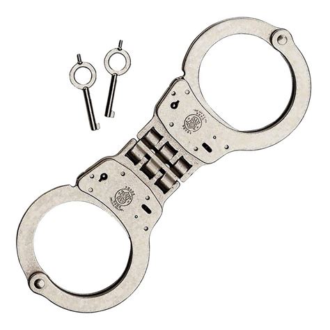 These are the only handcuffs on the market that have keyholes & double locking slots on both sides of the cheek plate. Smith & Wesson Nickel Hinged Handcuffs Model 300 | Zahal