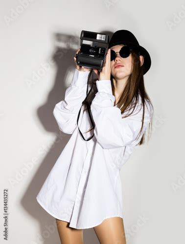 Naked Girl In A Man S White Shirt Sunglasses And Black Hat Holding