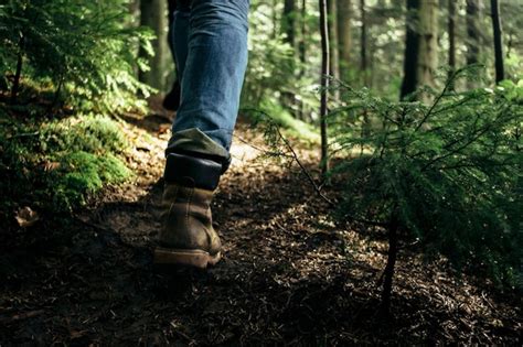 Premium Photo Legs Of A Person Walking Through A Forest