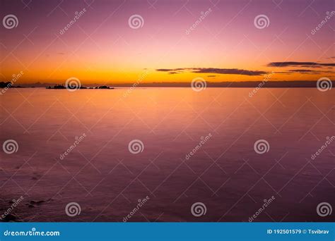 Vivid Purple Glowing Sunset Over Smooth Water Stock Image Image Of