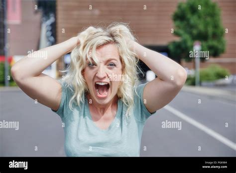 Portrait Of Screaming Woman Pulling Her Hair Stock Photo Alamy