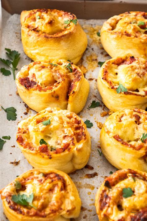 Close Up Of 8 Pizza Scrolls On A Baking Tray