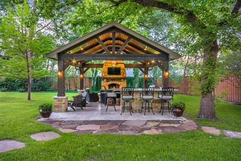 This Freestanding Covered Patio With An Outdoor Kitchen And Fireplace