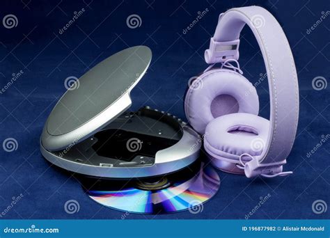 Cd And Cd Player And Headphones On A Blue Background Stock Photo