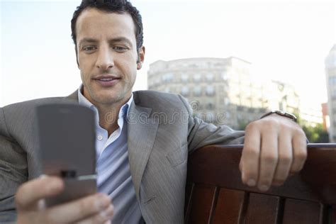 Businessman Text Messaging On Mobile Phone Outdoors Stock Image Image