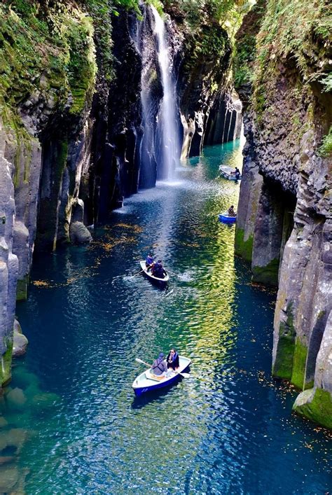 Two Boats In The Water Near A Waterfall
