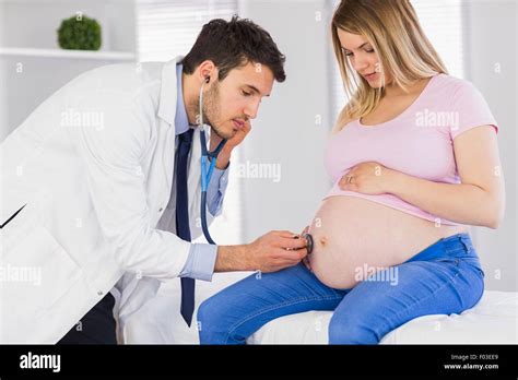 Male Doctor Listening Belly Stethoscope Hi Res Stock Photography And