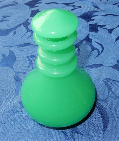 Many of the bowls and glass vases from this era are highly sought after. Uranium glass perfume bottle | Collectors Weekly