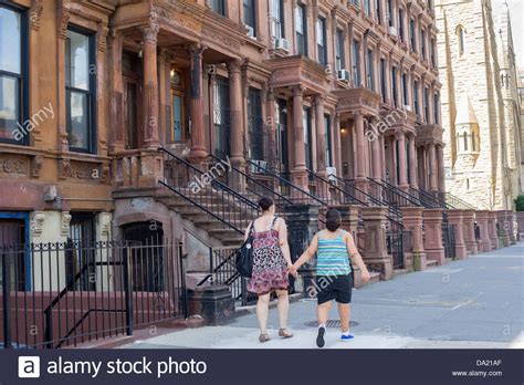 A Group Of Brownstones On A Block In The Harlem Neighborhood Of New