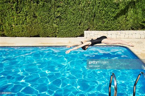 Mature Woman Diving Into Swimming Pool Photo Getty Images