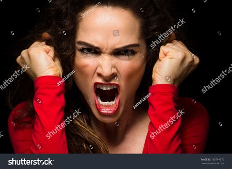 A Very Angry Aggressive Woman Is Clenching Her Fists In Rage Stock