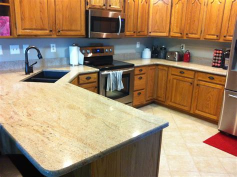 You can follow a similar design path as quartz when using this material for your countertops. Granite America Large Light Colored Kitchen - Granite America