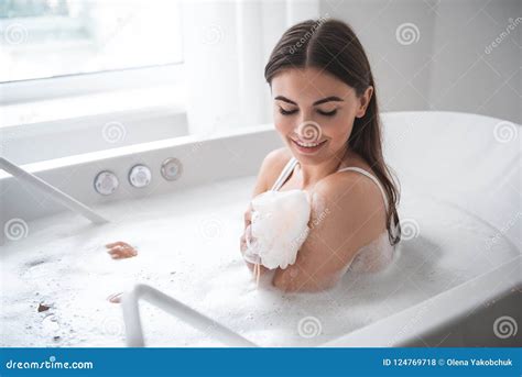 Pleased Female Washing Body With Shower Sponge Stock Photo Image Of Laugh Glad