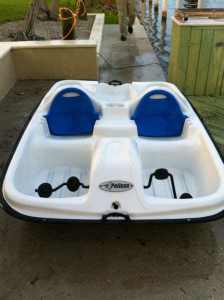 This boat has a seat along either side of the steering console and one in the back along the console itself. Pelican Paddle Boat Boats for sale