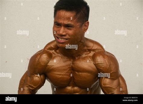 Bodybuilder Shows His Muscles At A Competition In Bangkok Thailand Stock Photo Alamy