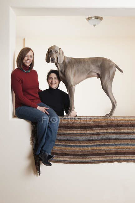 Lesbian Couple Posing With Weimaraner Dog In Wall Niche — Homosexual