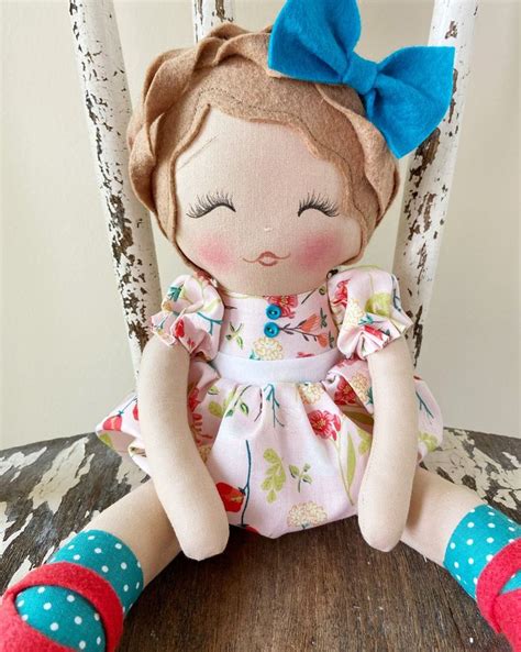 A Doll Sitting On Top Of A Wooden Chair