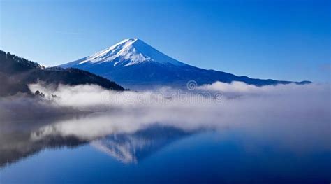 Reflection Of Mount Fuji In Calm Water And Morning Fog Stock Photo