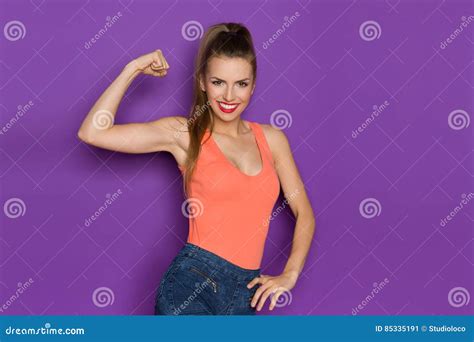 Young Beautiful Woman Flexing Biceps Stock Image Image Of Jeans