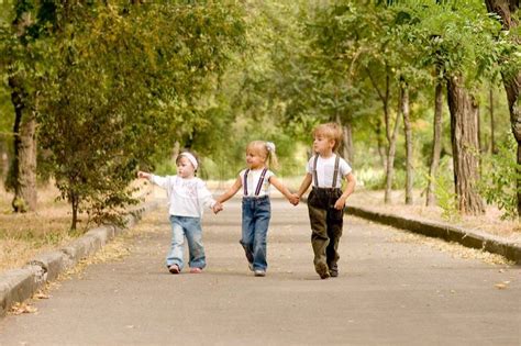 Three Young Friends Go For A Walk The Park Stock Photo Colourbox