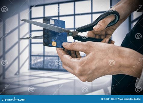 Composite Image Of Businesswoman Cutting Credit Card With Scissors