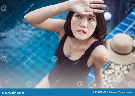 Beautiful And Asian Woman Wearing Bikini Sitting On Swimming Pool Summer Vacation Concept Stock