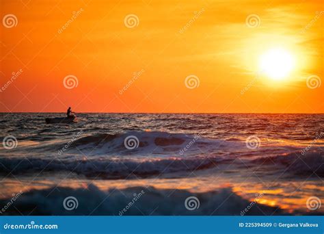 Fisherman Sailling With His Boat On Beautiful Sunrise Over The Sea