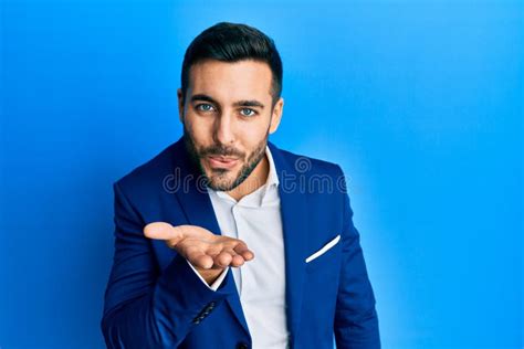 Young Hispanic Businessman Wearing Business Jacket Looking At The