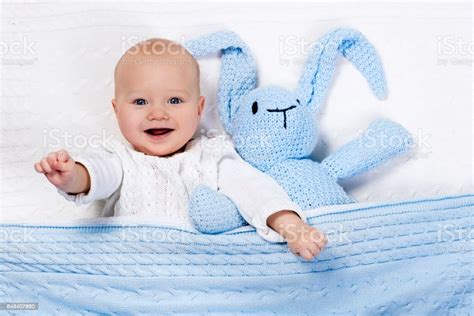 Baby Boy Playing With Bunny Toy In Bed Stock Photo Download Image Now