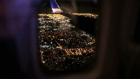 Airplane Window Seat View Of Los Angeles At Night And Wing Of Plane