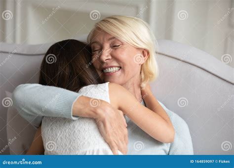 50s Grandmother Embracing Granddaughter Enjoy Moment of Tenderness