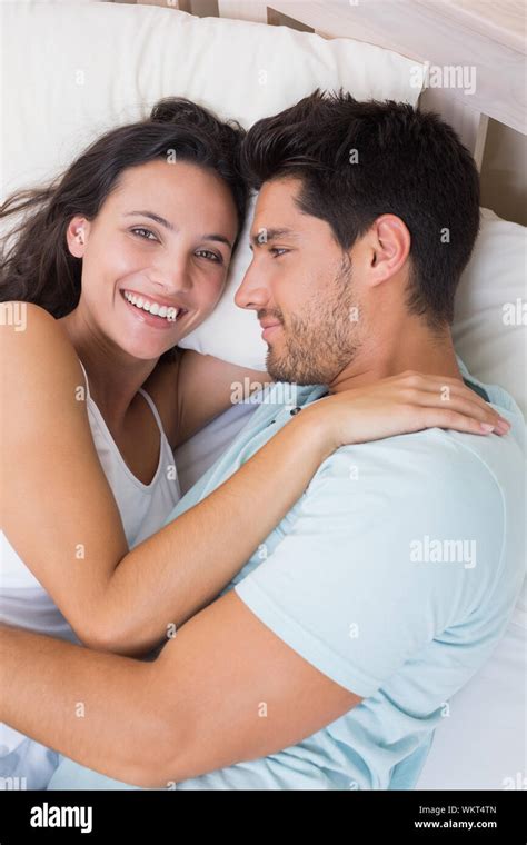 Attractive Couple Cuddling On Bed Hi Res Stock Photography And Images