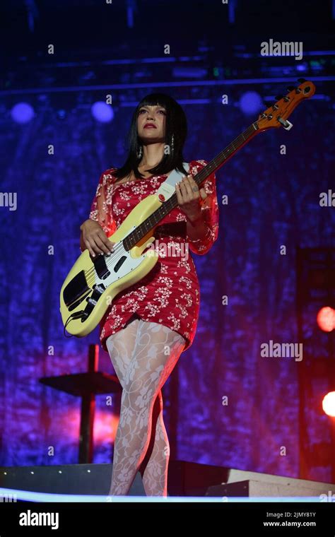 Bassist Laura Lee Of Khruangbin On Stage Wearing A Red Floral Mini