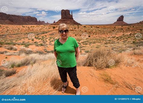 Senior Middle Aged Woman 60s Posing In Front Of Monument Valley Utah