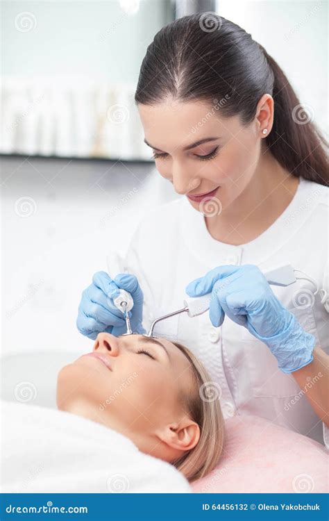 Attractive Young Beautician Is Treating Her Stock Photo Image Of