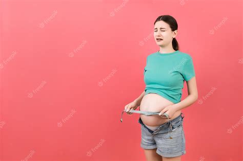 Premium Photo Cropped Image Of Expecting Mother In Unzipped Jeans