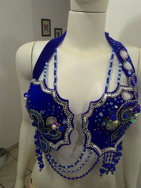 A Mannequin Wearing A Blue And White Bra With Beads On Its Chest