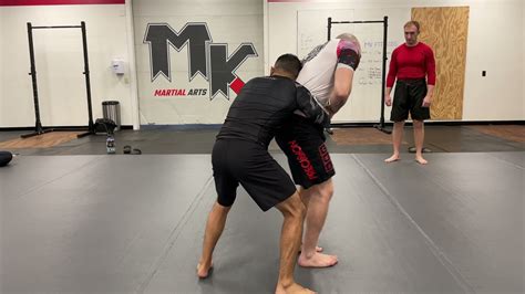 Transition To The Rear Clinch Knee Drop Takedown And Kimura Control