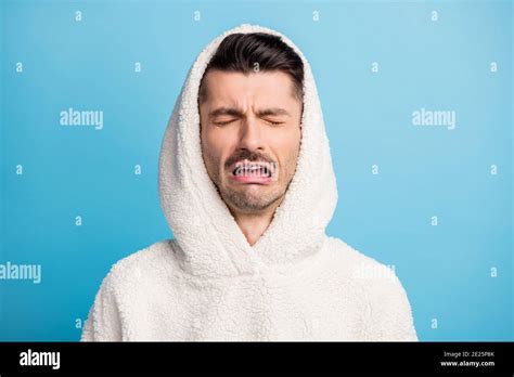 Photo Portrait Of Crying Guy Wearing Wool Hood Isolated On Pastel Blue