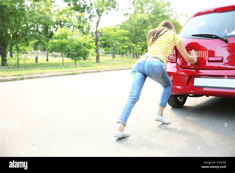 Woman Pushing Red Car Stock Photo Alamy